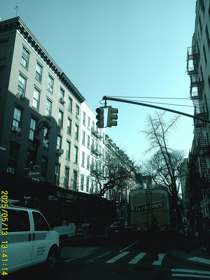 Upside-down view of a city street with a tall building, crane, and vehicle.