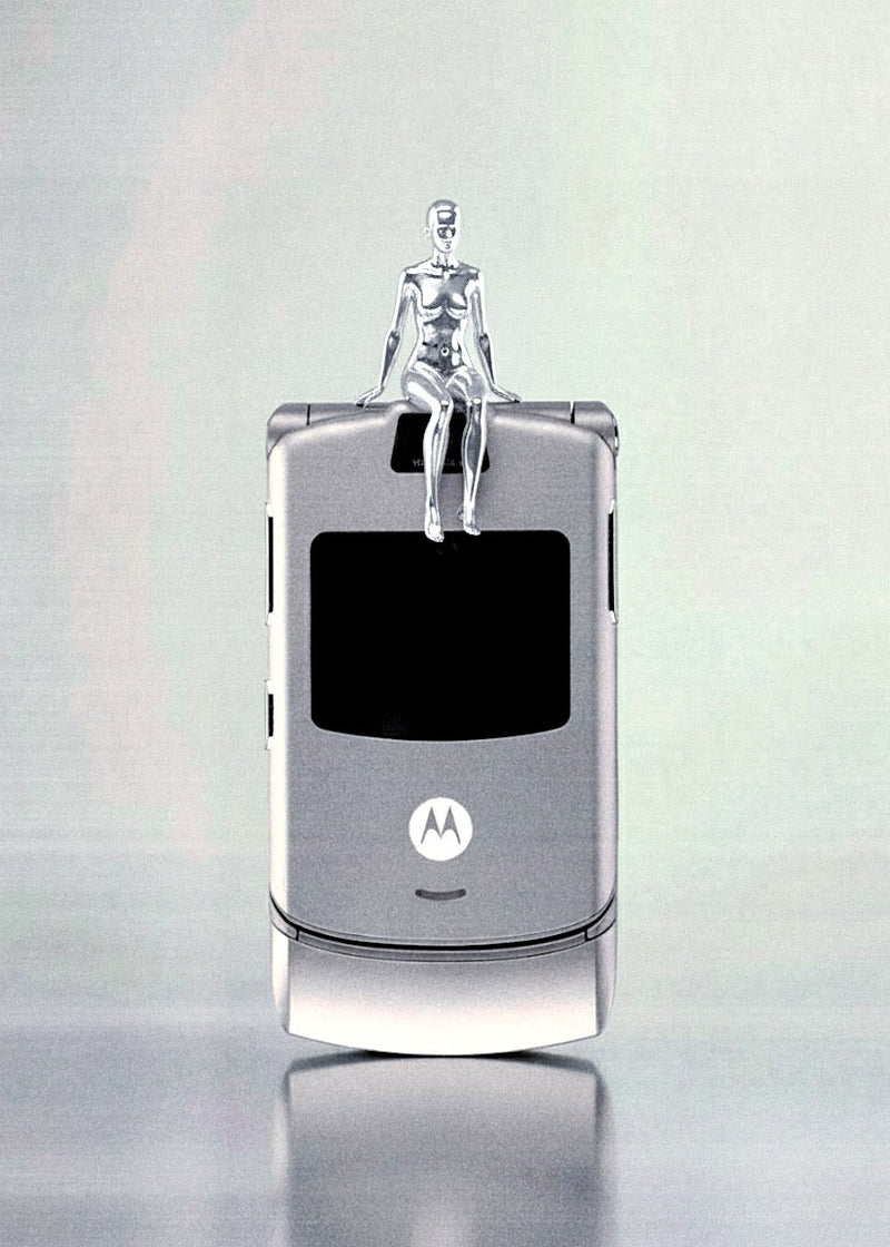 Motorola Razr phone on a reflective surface with a light gray background